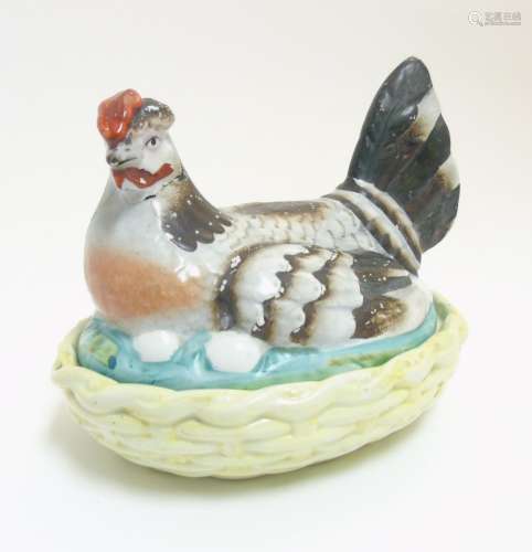 A 19thC Staffordshire hen on nest tureen with yellow basket,