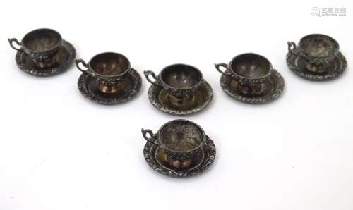 A set of 6 19thC / 20thC white metal miniature dolls house tea cups and saucers.