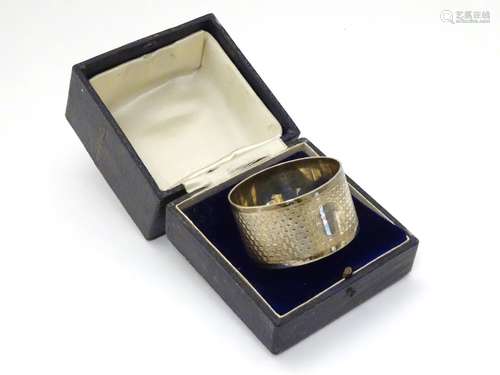 A silver serviette ring hallmarked Birmingham maker William Hair Haseler.