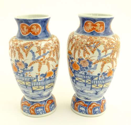 Two Imari vases depicting a garden landscape. Approx. 12