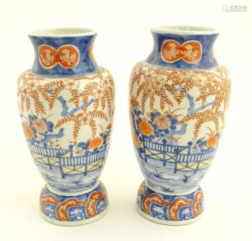 Two Imari vases depicting a garden landscape. Approx. 12