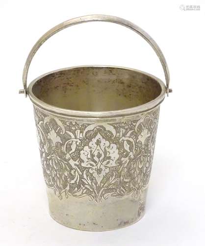 A small white metal bucket with engraved decoration and marked under,