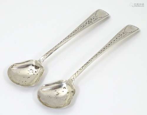 A pair of 19thC silver salt shovels with bright cut decoration.