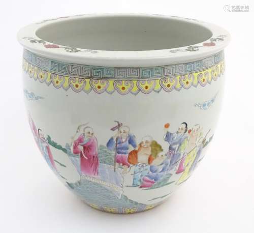 A Chinese jardiniere decorated with Chinese figures in landscapes and a Greek key decorative border