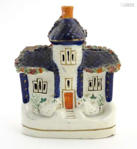 A Staffordshire pottery flat back house. Approx. 6 1/2” tall x 4 1/2” wide.