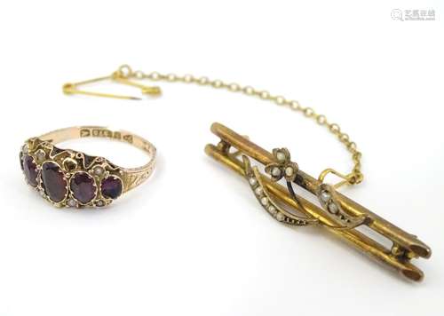 A 9ct gold ring set with 5 graduated garnets together with a 9ct gold bar brooch set with seed