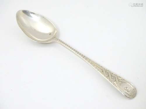 A Scottish silver teaspoon with engraved decoration. Hallmarked Glasgow 1884 maker Wilson & Sharp.