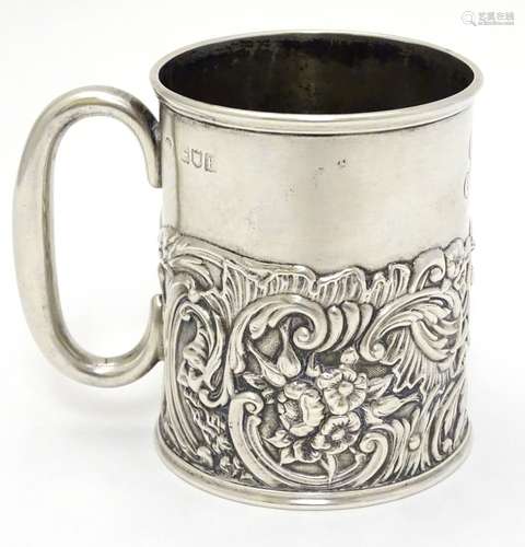 A silver Christening mug / tankard with acanthus, C-scroll, dolphin floral and mask decoration.