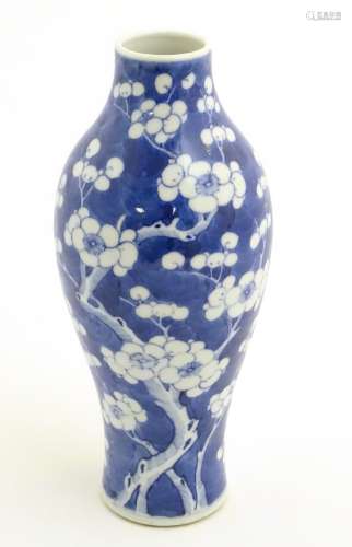 A Chinese blue and white vase decorated with prunus, Chinese character marks to base. Approx.