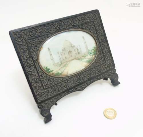 An Indian carved hardwood easel frame, the large oval image of the Taj Mahal .