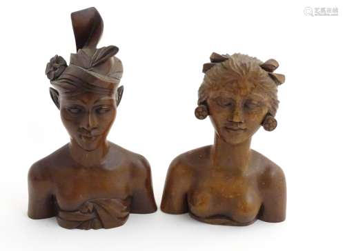 A pair of carved hardwood Polynesia bust figures , male and female.