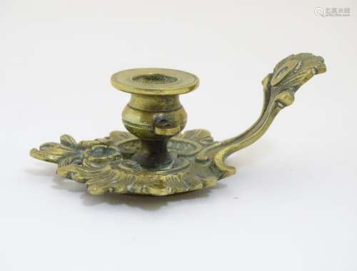 A 19thC Rococo style small proportion brass chamberstick 3 1/2