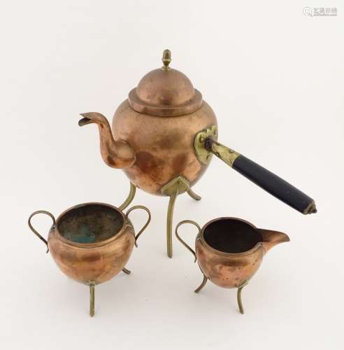 Arts and Crafts: a three-piece side handled copper and brass coffee set standing on 3 brass feet,