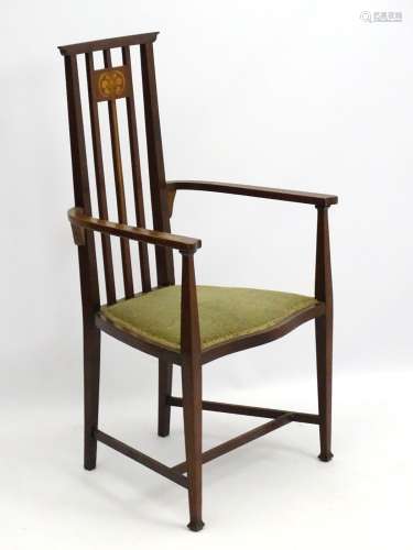 An Arts and Crafts Liberty style mahogany inlaid high back open armchair with shaped arms and legs