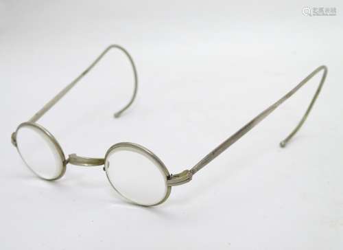 A pair of nickel reading spectacles / glasses of circular design.