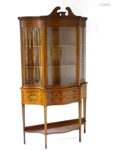 A late 19thC / early 20thC ‘Edwards & Roberts’ serpentine fronted display cabinet with profuse