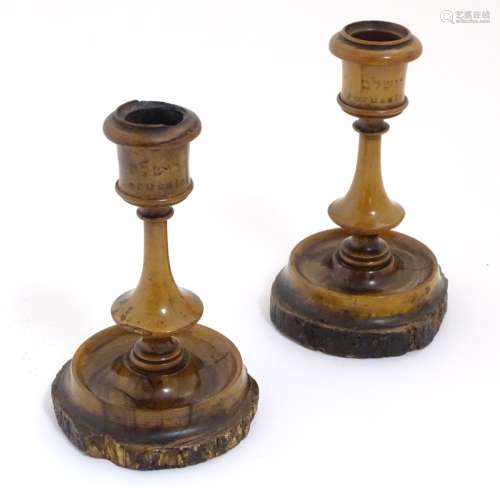 A pair of olive wood Jerusalem candlesticks with Hebrew and English script.