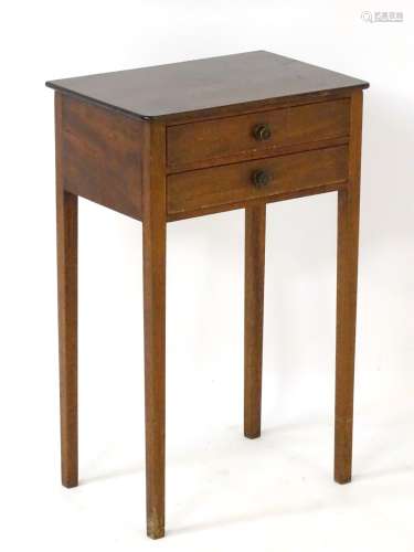 A late 19thC / early 20thC mahogany bedside table having two short drawers with brass knob handles