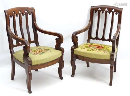 A pair of French 19thC mahogany library chairs in the Gothic manner,