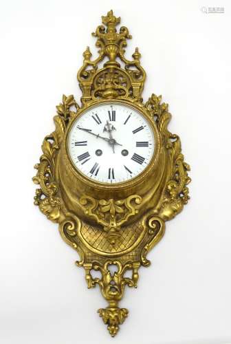 Cartel Clock : A Neo - Classical Louis XVI Style cast brass Cartel clock .