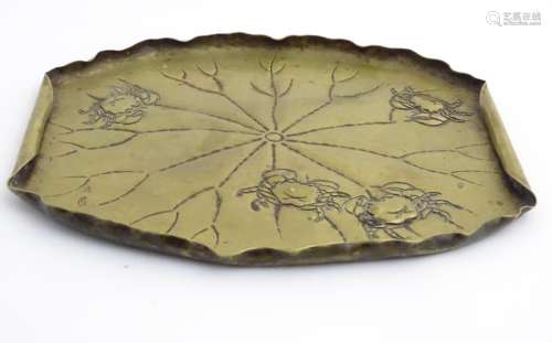 A Japanese signed brass embossed leaf form having four crafts embossed decoration.