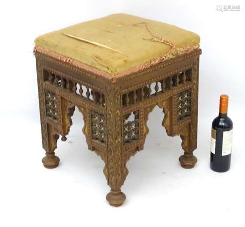 A late 19thC / early 20thC Moorish style walnut stool with upholstered square seat above spindled