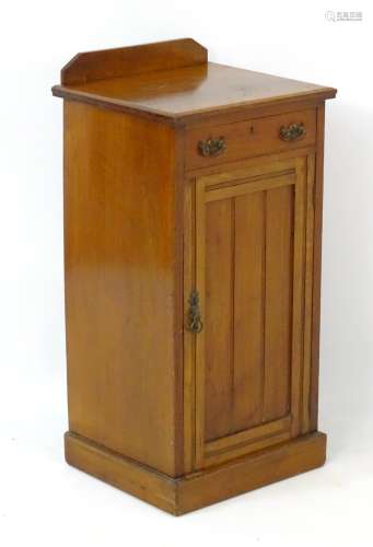 A late 19thC / early 20thC mahogany cabinet with canted upstand above single short drawer and