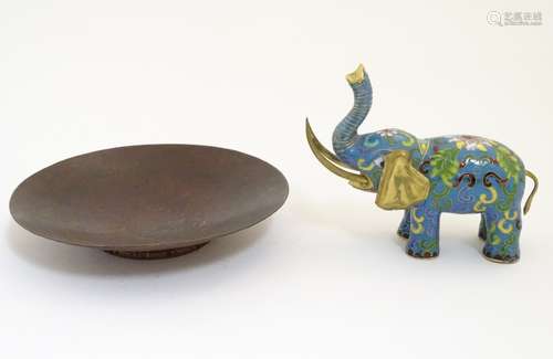 A hammered copper dish together with a cloisonne and gilt decorated elephant.