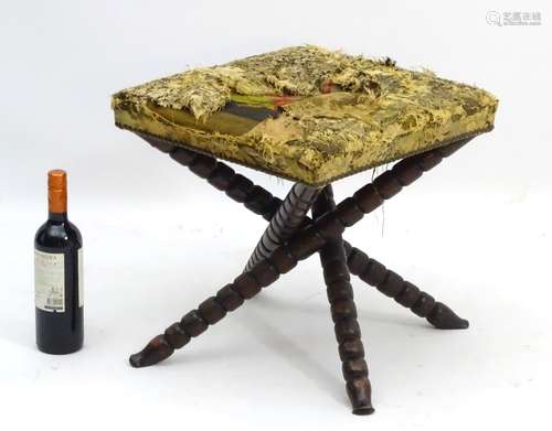 A late 19thC walnut stool with upholstered squared top and brass stud work,