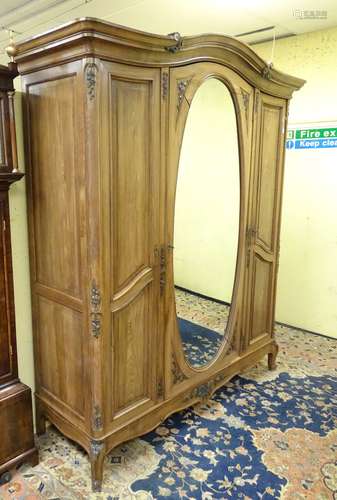 An early 20thC triple armoire with painted floral decoration and applied mouldings,