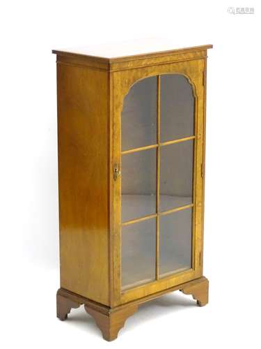 A mid / late 20thC glazed burr walnut cabinet with astragal glazed door containing two shelves,