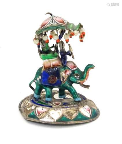 An Indian figure of an elephant with howdah and figures, having enamel decoration.