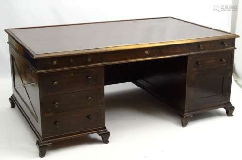 A large early 20thC double pedestal desk with four short drawers beside single central drawer