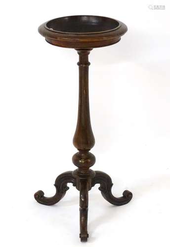 A 19thC rosewood jardiniere stand with a tapering baluster turned column and tripod base,