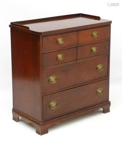 A mid 20thC mahogany chest of drawers comprising four long drawers with Georgian style handles and