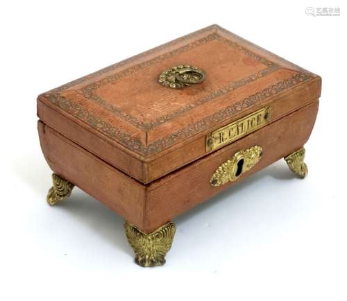 A Regency gold tooled leather covered small sewing box with gilded legs,