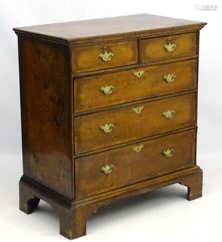 A Queen Anne style walnut chest of drawers comprising two short over three long drawers,