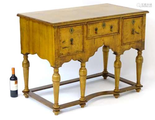 An early 18thC walnut sideboard with herringbone and cross banded rectangular top above one short