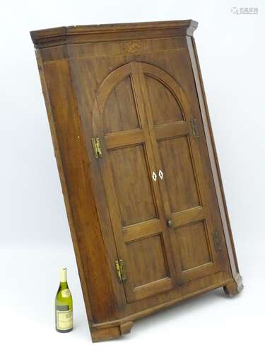 A late 18thC corner cupboard with marquetry inlay to the frieze with boxwood stringing,