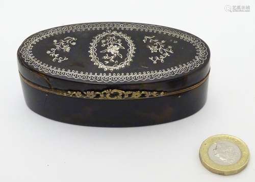 A 19thC tortoiseshell silver inlaid hinged lidded box with silver gilt facings.