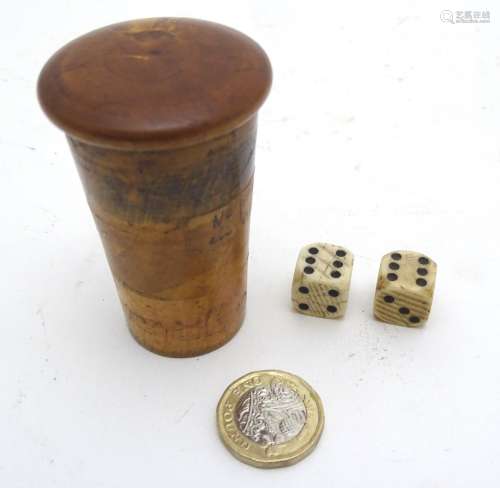 Two 19 thC French bone dice together with a round wooden cup shaker and lid,