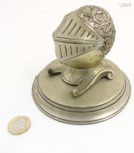 A nickel desk stand in the form of a knight's helmet,