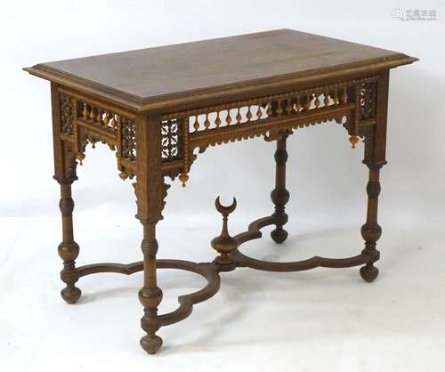 A late 19thC / early 20thC walnut Moorish style table with rectangular moulded top above spindled