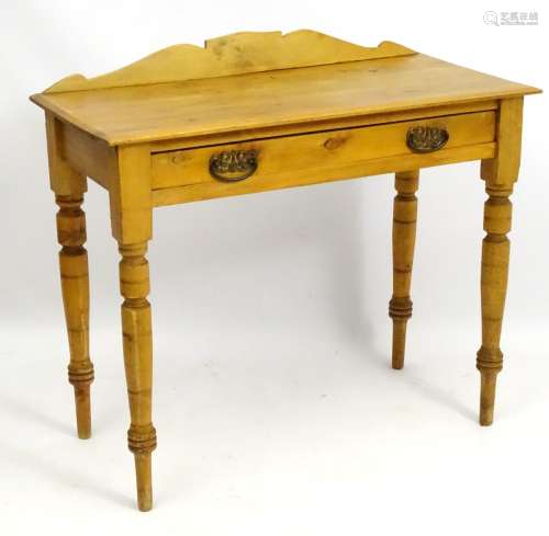 A late 19thC / early 20thC pine side table with shaped up stand and single long drawer,