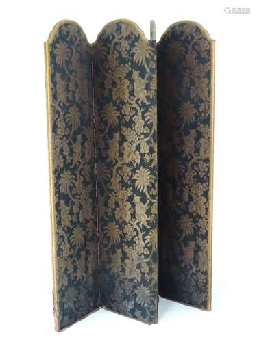 A mid / late 20thC folding dressing screen with oriental designed fabric.