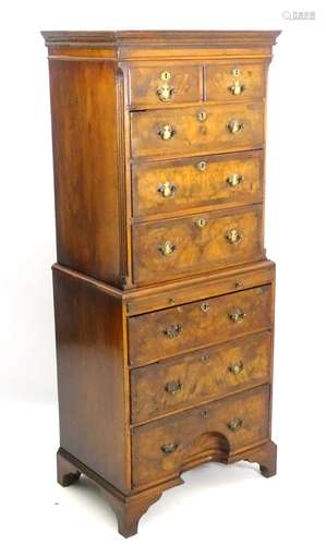 An early 20thC walnut chest on chest with moulded cornice above chanted fluted corners,