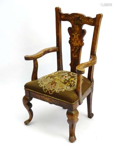 An early 20thC Queen Anne style beech child's chair with floral painted decoration throughout,