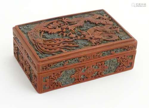 A Chinese cinnabar lacquer carved lidded box having image to top of a four toed dragon fighting a