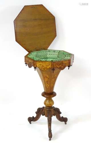 A late 19thC / early 20thC walnut trumpet sewing table with octagonal top,