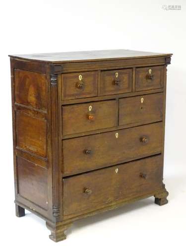 A mid 18thC oak chest of drawers with molded rectangular top above a chamfered frieze,
